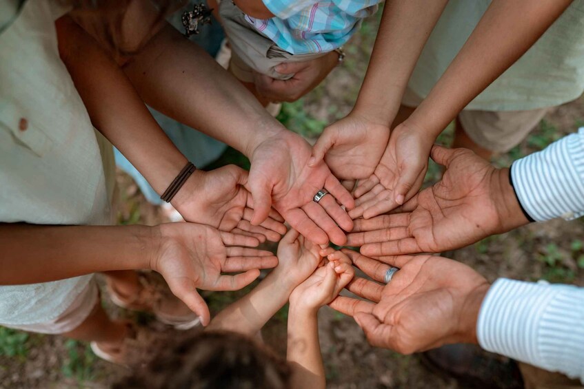 A group of hands joined together in a circle. 5
