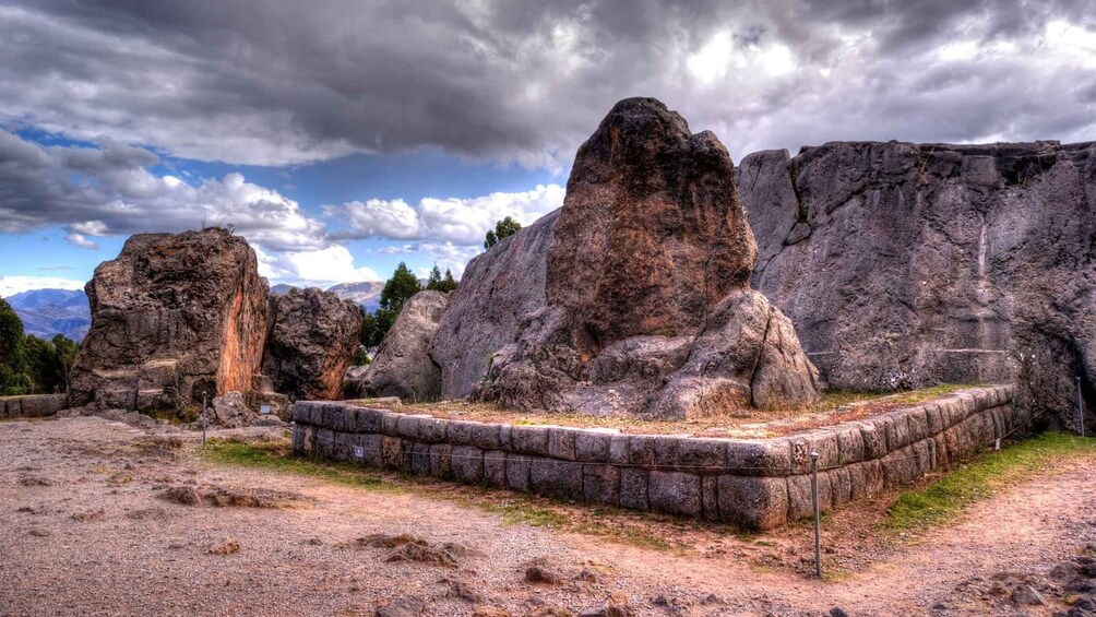 A rocky landscape with large boulders and a stone platform. 5