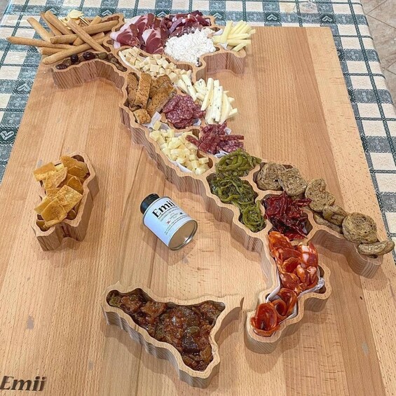 A wooden board with various food items arranged in a map-like pattern. 4