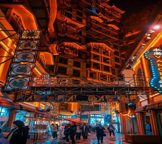 A crowded urban street with illuminated signs and traditional architecture. 4
