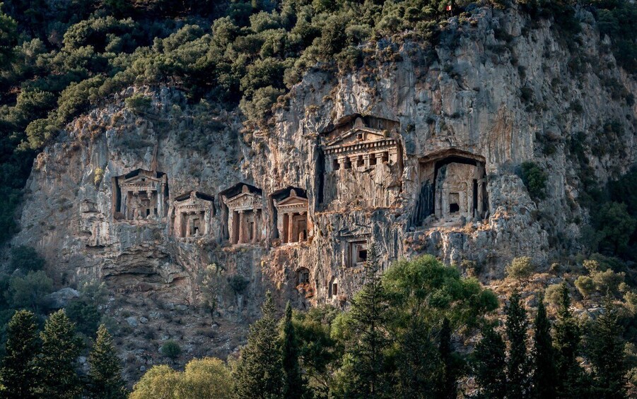 Ancient rock-cut tombs on a cliffside. 1