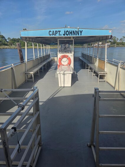A boat named 'Capt. Johnny' with a lifebuoy and a sign reading 'PFD's' on the deck. 2