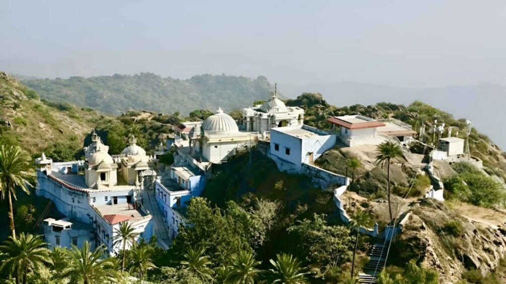 A hillside monastery complex with multiple domed structures and buildings. 3
