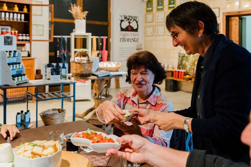 A person serving food to another person at a table in a cafe. 2