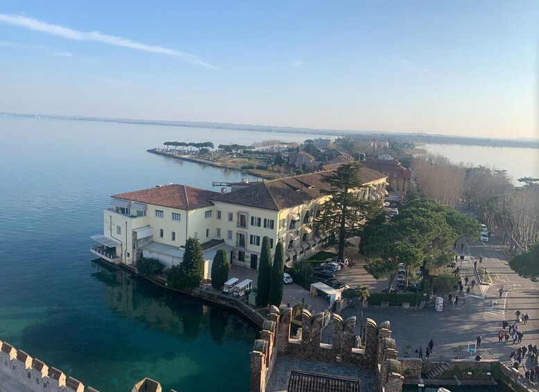 A waterfront property with a large building, a bridge, and a calm lake. 1