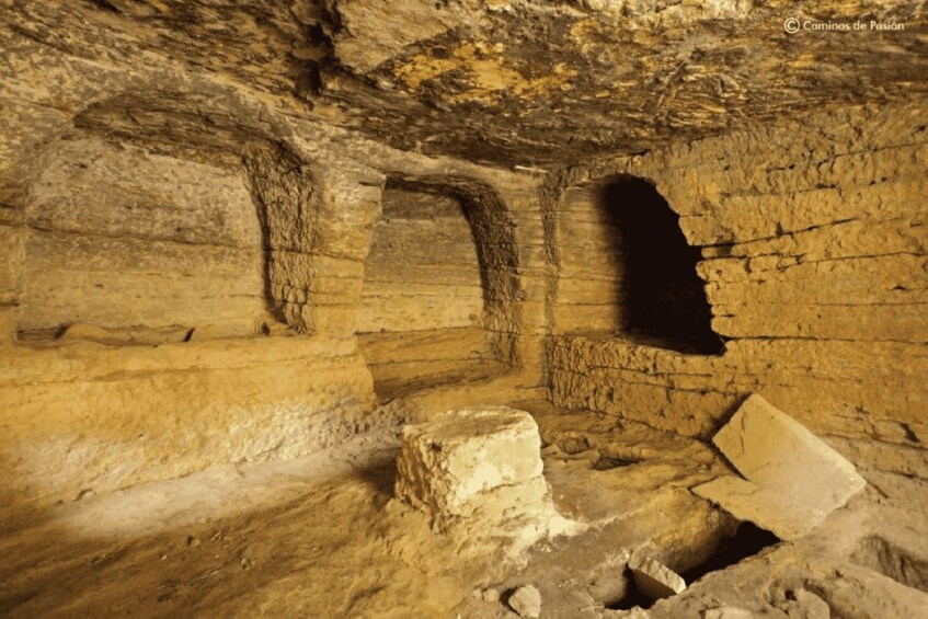 An underground cave with natural rock formations and a large opening. 2