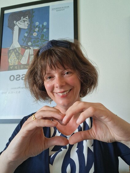 A person making a heart shape with their hands. 3