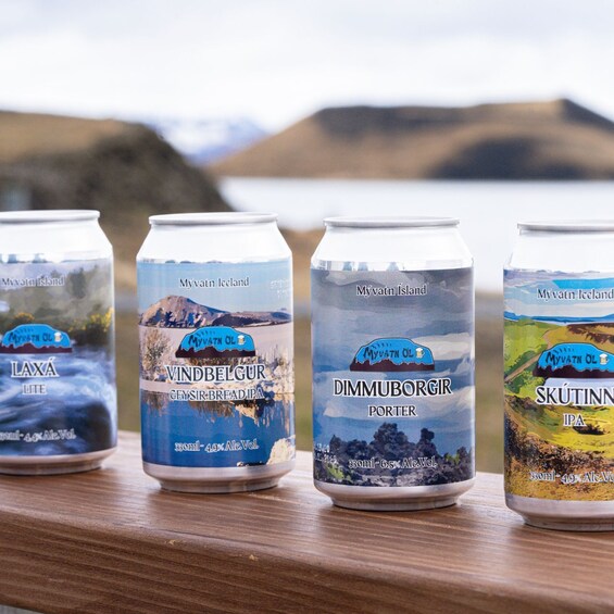 Four cans of beer with labels depicting Icelandic landscapes. 4
