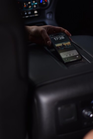 A hand holding a smartphone displaying the time 17:28. 3