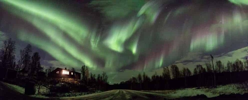 A house under a night sky with the Northern Lights. 3