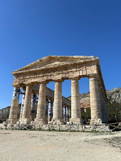 Ancient Greek columns with a stone structure above them. 1