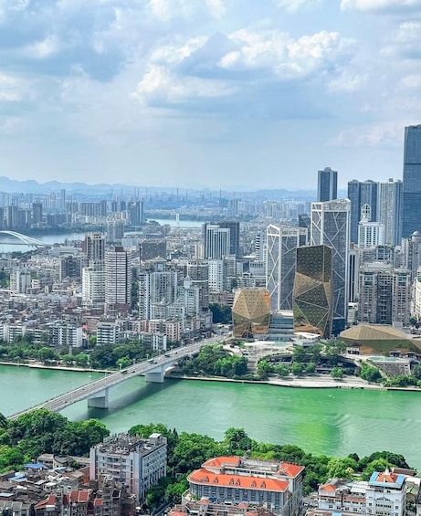A cityscape with a river, modern buildings, and a bridge. 2