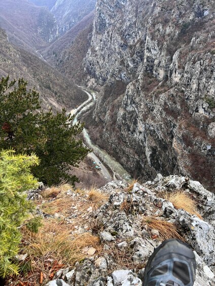 A mountainous landscape with a winding road, rocky terrain, and sparse vegetation. 2