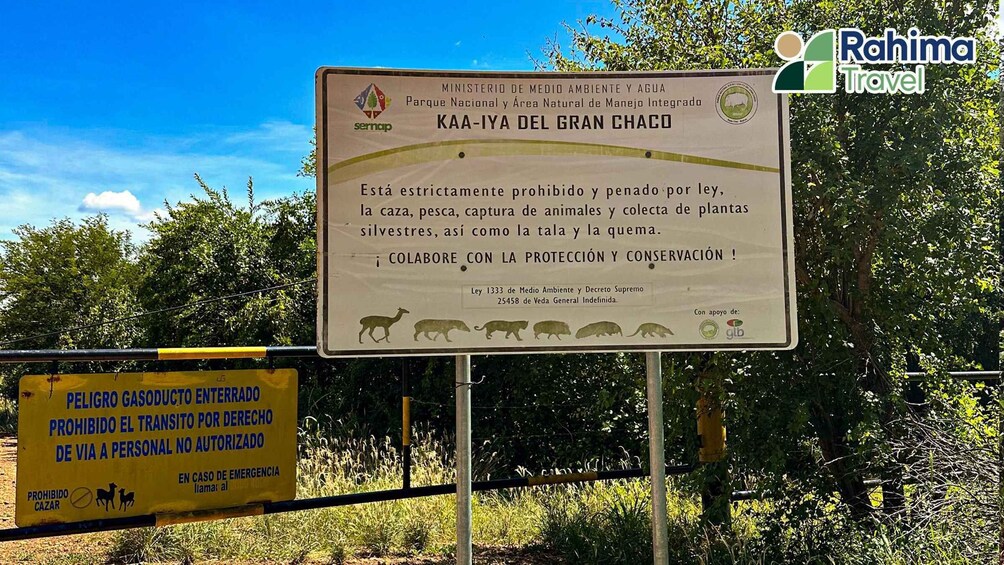 A signboard with environmental protection information and a yellow warning sign about gas danger. 3