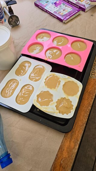 A baking tray with two different types of molds containing batter. 2