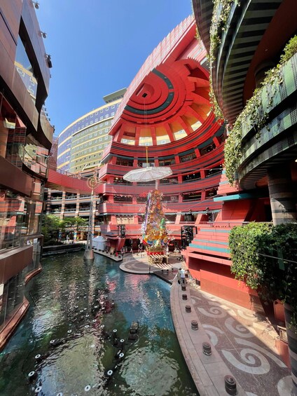 A modern building with a circular atrium, a central fountain, and a pool. 3