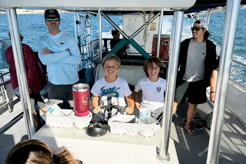 A group of people on a boat with a table in the foreground. 3