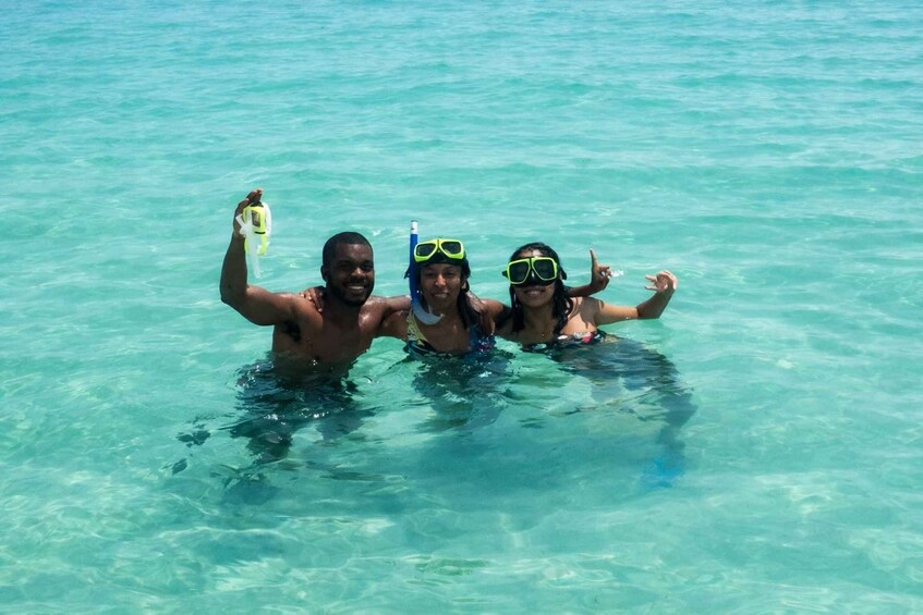Three people snorkeling in clear blue water. 2