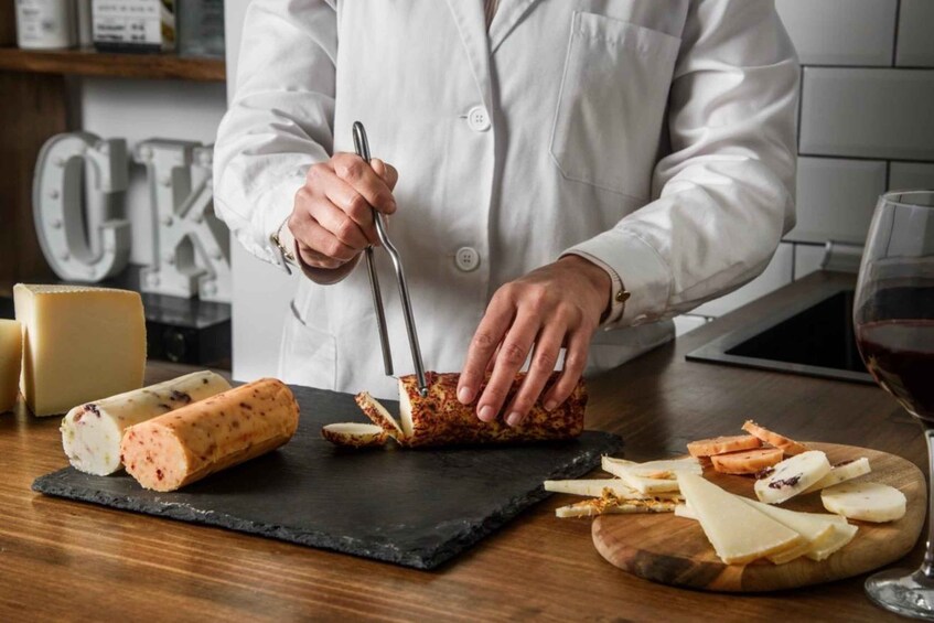 A person slicing a type of cured meat on a slate board. 2