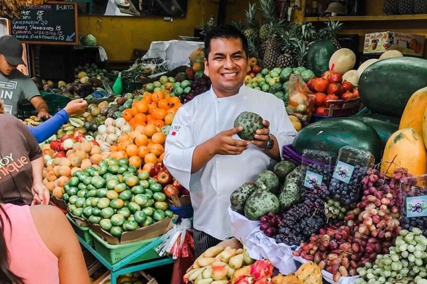 A fruit market with various fruits and vegetables on display. 2