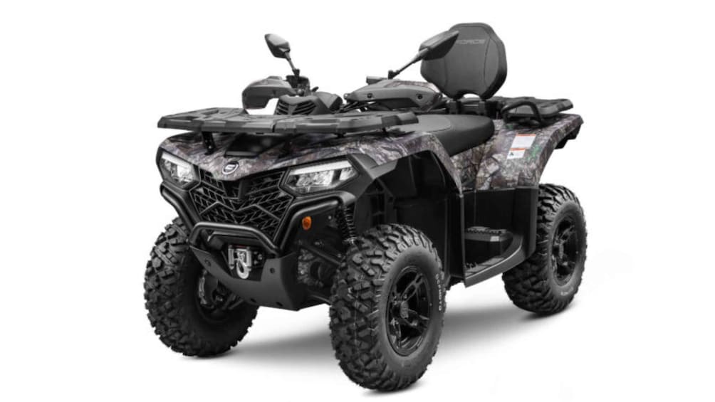 A four-wheeled ATV with a camouflage pattern, large tires, and a storage compartment on the back. 1