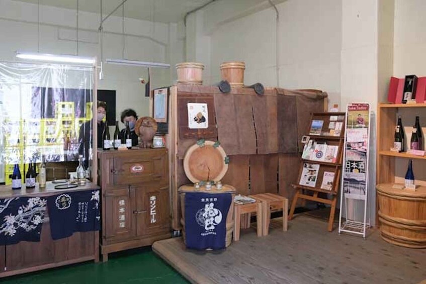 A room with wooden cabinets, a stool, and a display of wine bottles. 2