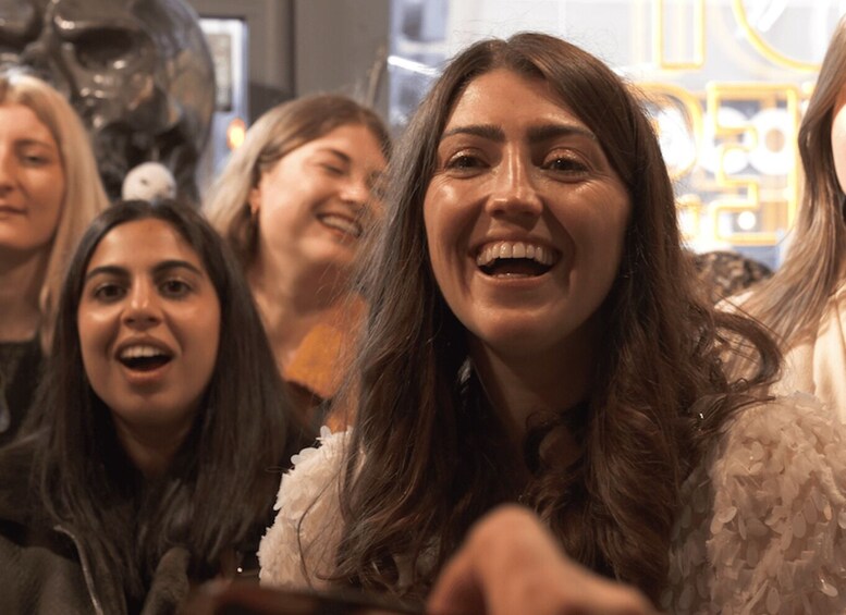 A group of people in a public indoor space with a decorative ceiling. 3