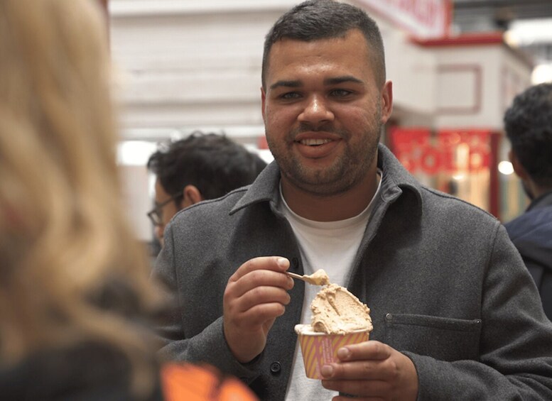 A person eating ice cream in an outdoor setting. 4