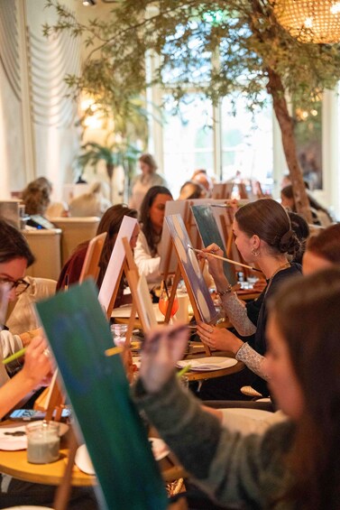 People painting at tables in a restaurant. 5