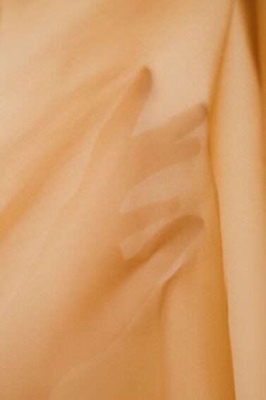 A close-up of a fabric with a smooth texture and a slight sheen. 3