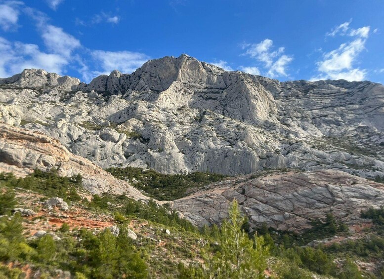 A rugged mountain landscape with rocky outcrops and sparse vegetation. 3