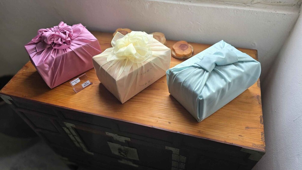 Three gift boxes on a wooden surface. 4