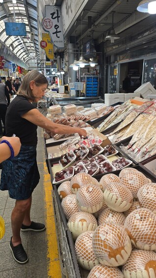 A market stall with various packaged goods, including dried fruits and snacks. 2