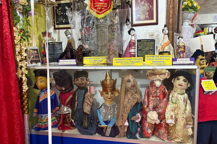A display of traditional puppets from various countries, including Indonesia, Myanmar, Thailand, and Japan. 2