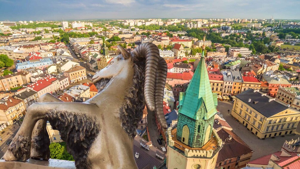 A cityscape with a prominent statue of a horse and a green-roofed church. 1