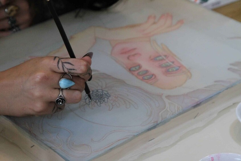 A person painting on a canvas. 2