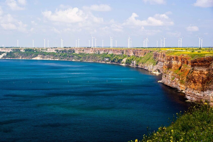 A coastal landscape with a cliff and a sea. 5