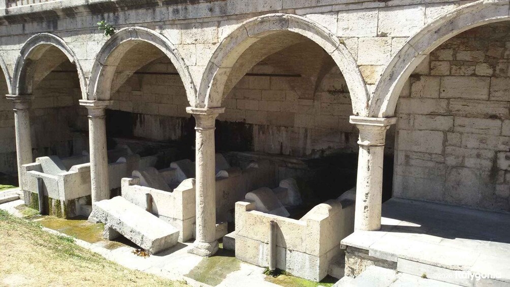 A stone structure with arches and steps. 2