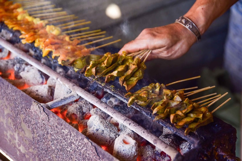 Skewers of grilled meat over an open flame. 1