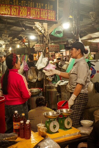 A street food vendor preparing food at a market stall. 3