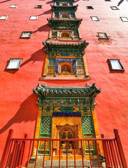 A multi-tiered temple with intricate carvings and vibrant colors. 2