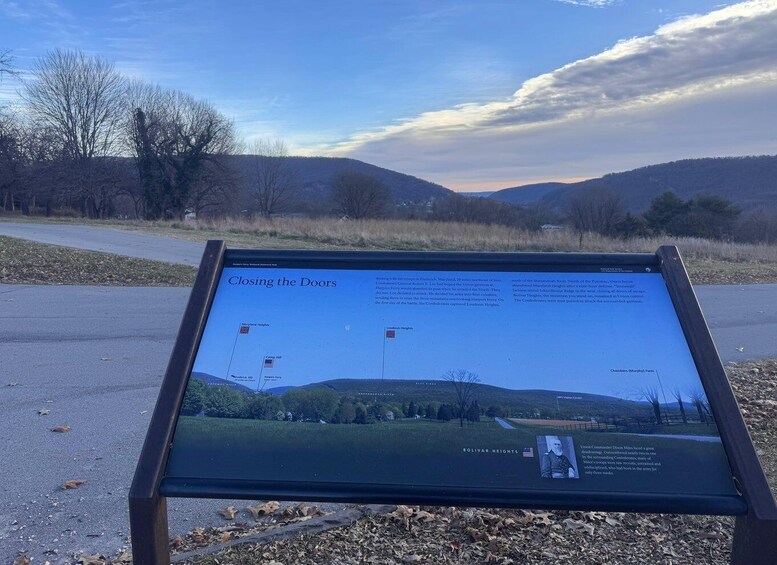 A historical marker titled 'Closing the Doors' with a landscape view of hills and trees in the background. 2