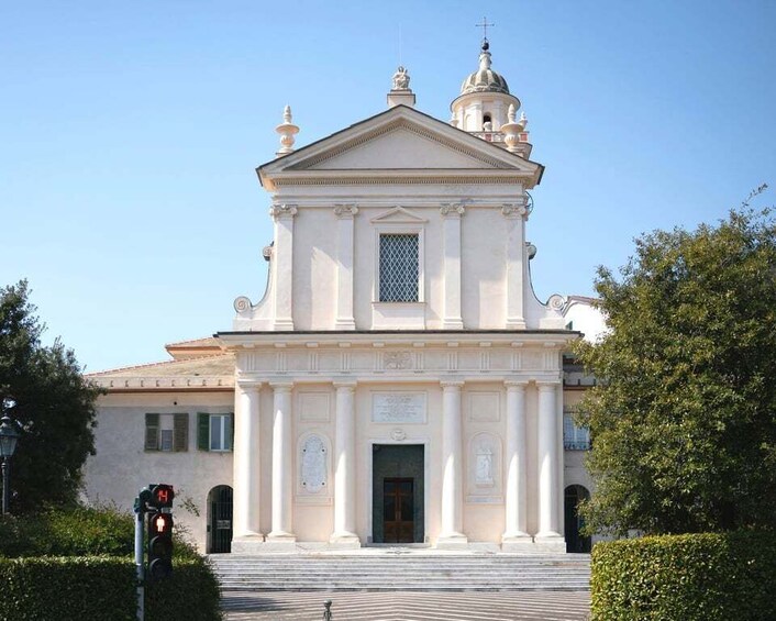 A white church with a dome and columns. 3