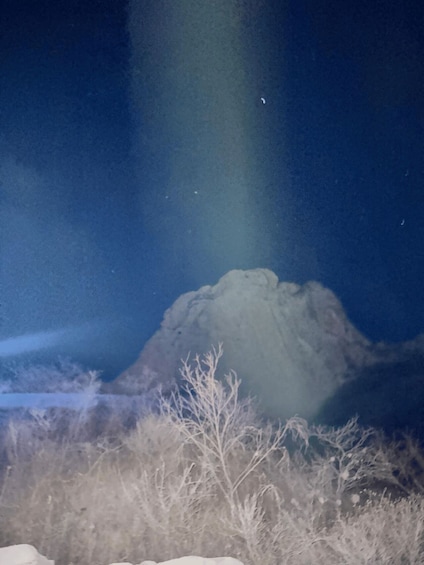 A snow-covered landscape with a mountain in the background and a clear sky. 5