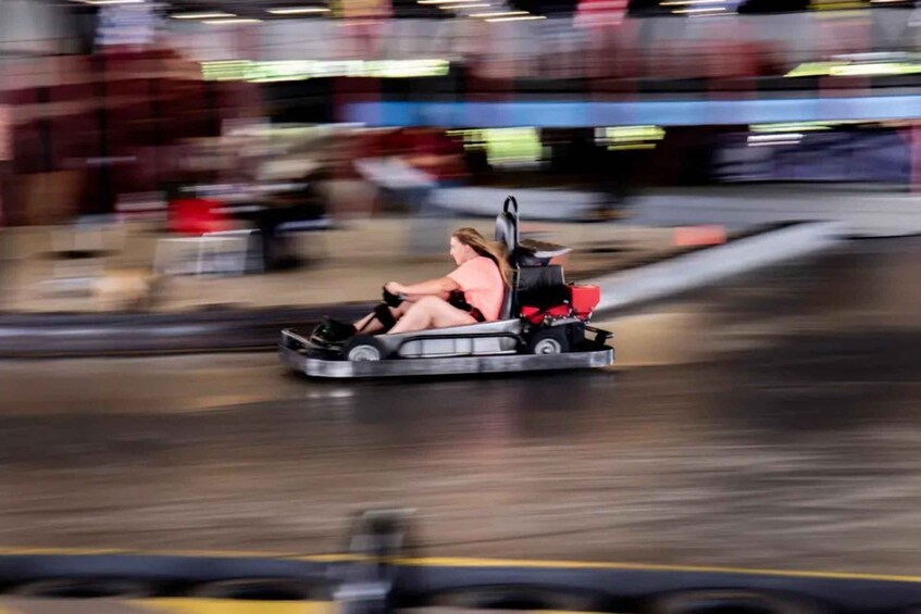 A go-kart on a track with a blurred background. 3