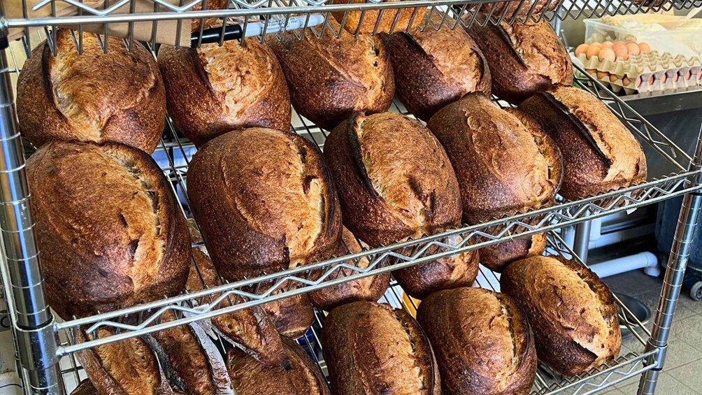 A rack of freshly baked loaves of bread. 5