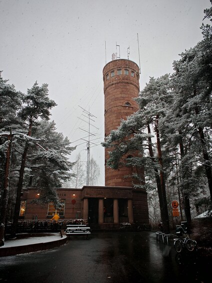 A snow-covered tower, a building with columns, and a bicycle. 3