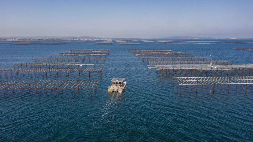 A boat navigating through a series of floating metal structures in a large body of water. 4