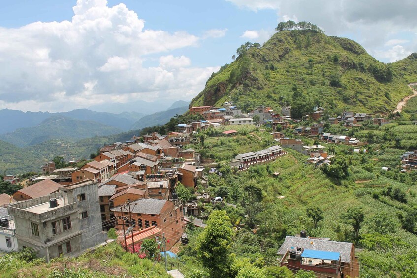A hilly village with terraced fields and traditional houses. 2
