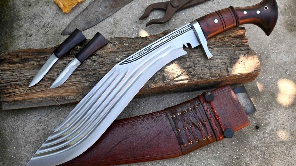 A large knife with a wooden handle and a leather sheath. 3
